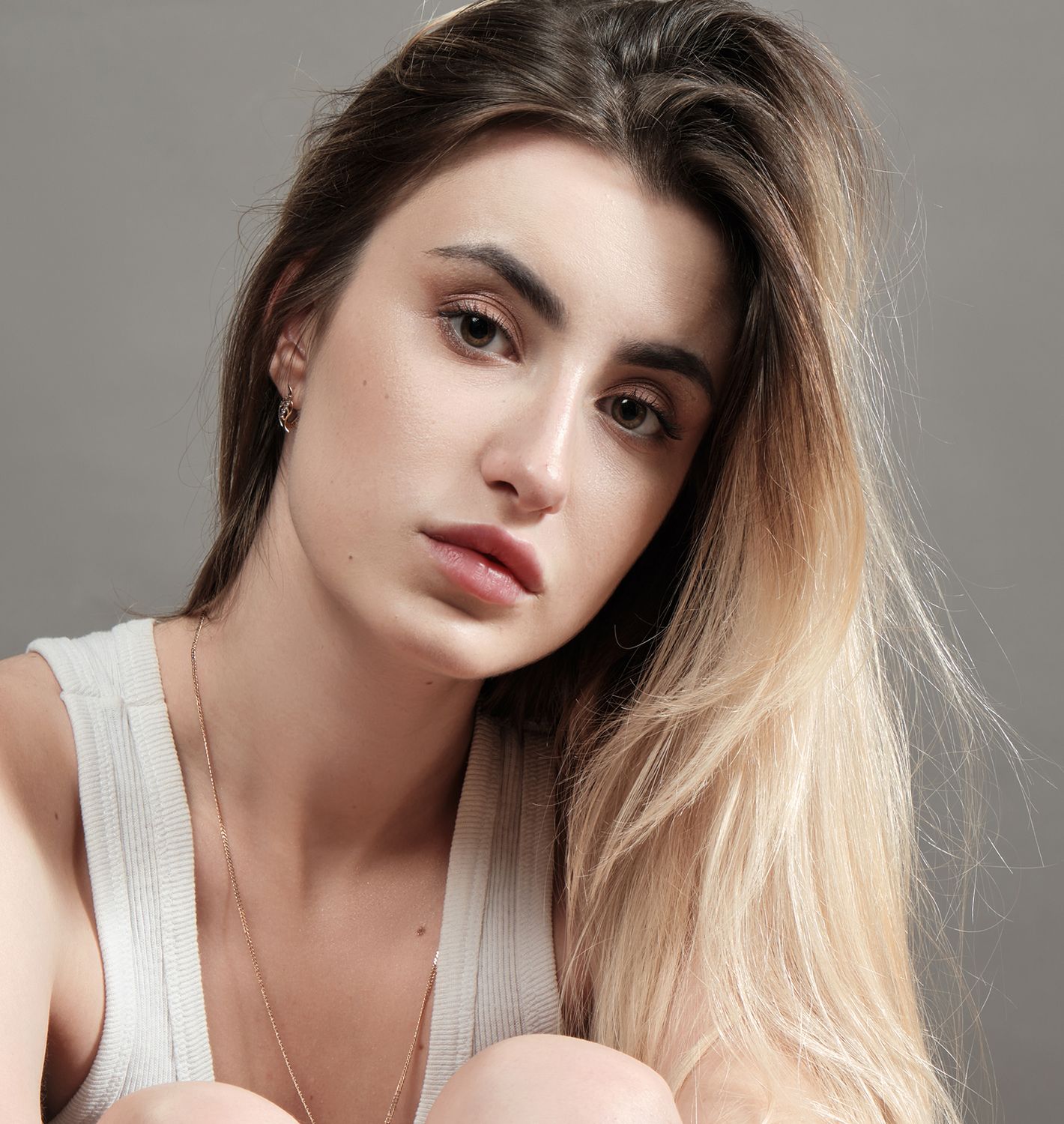 Woman in a swimsuit relaxing by the pool.