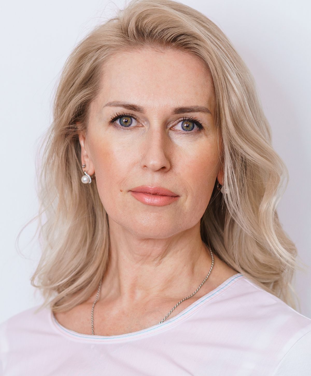 Portrait of a woman with blonde hair.