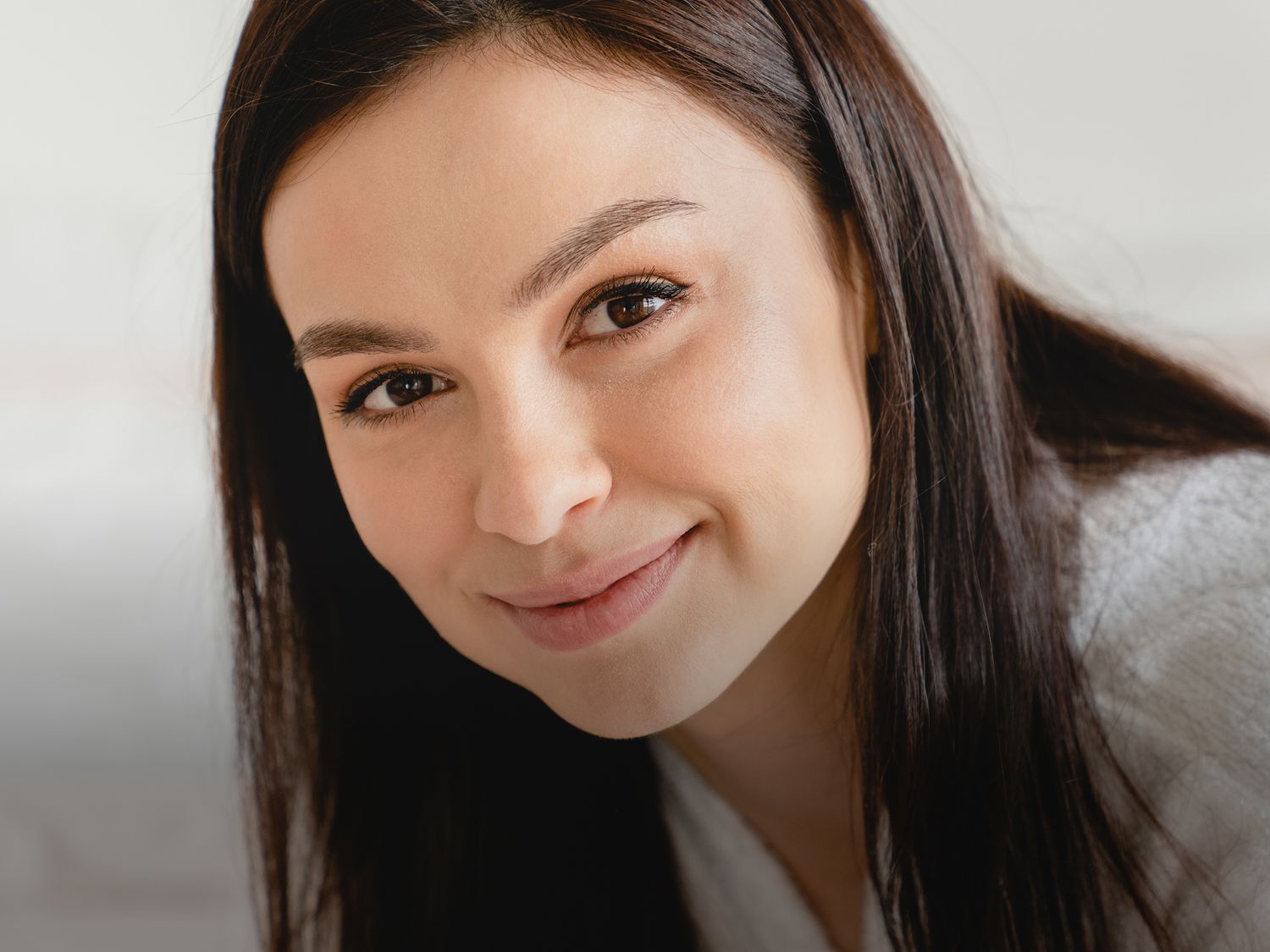 Portrait of a young woman with curly hair.