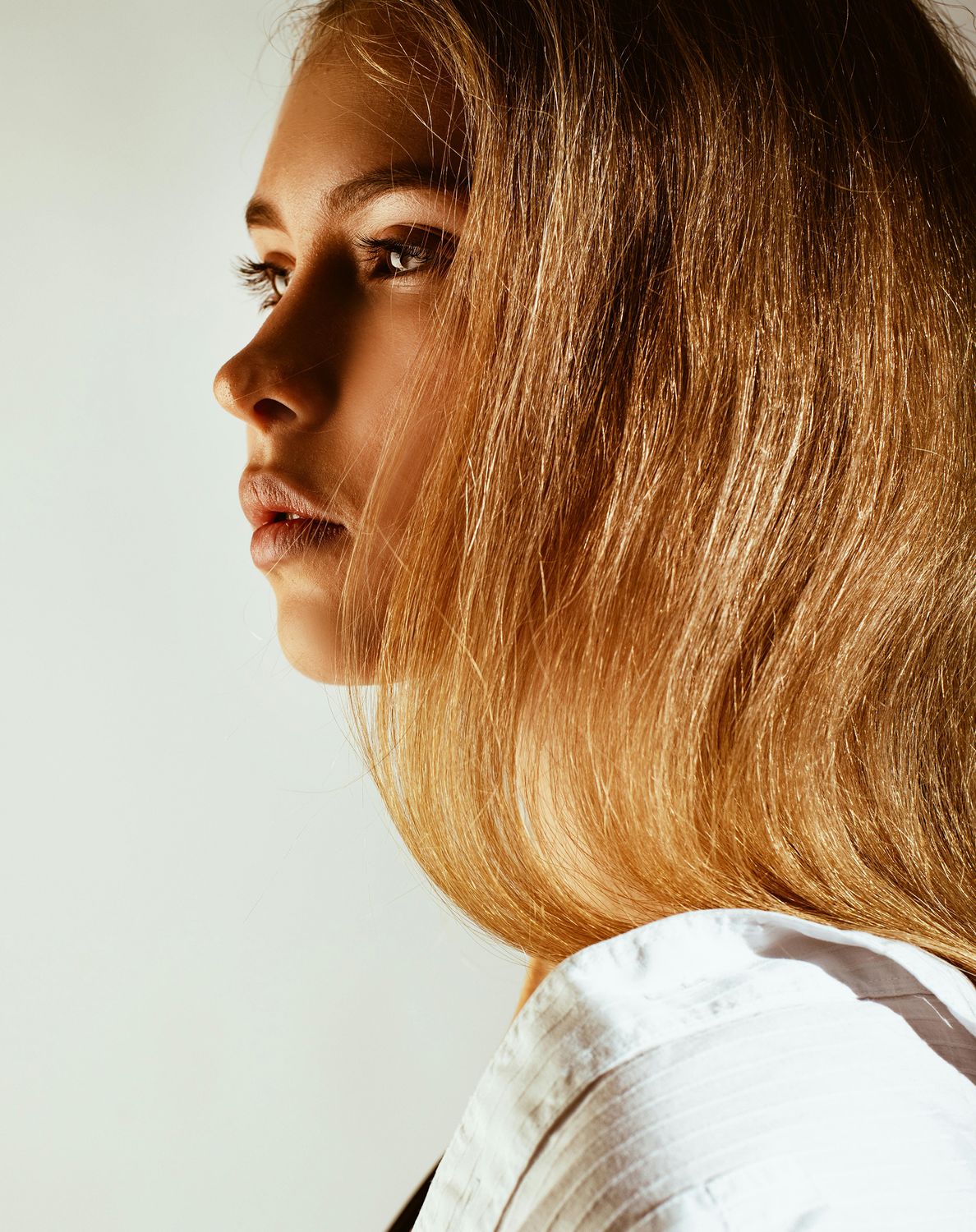 Profile of a young woman with long hair.