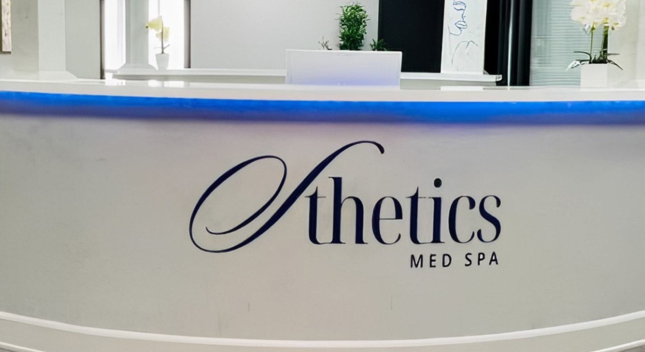 Med spa reception desk with logo.