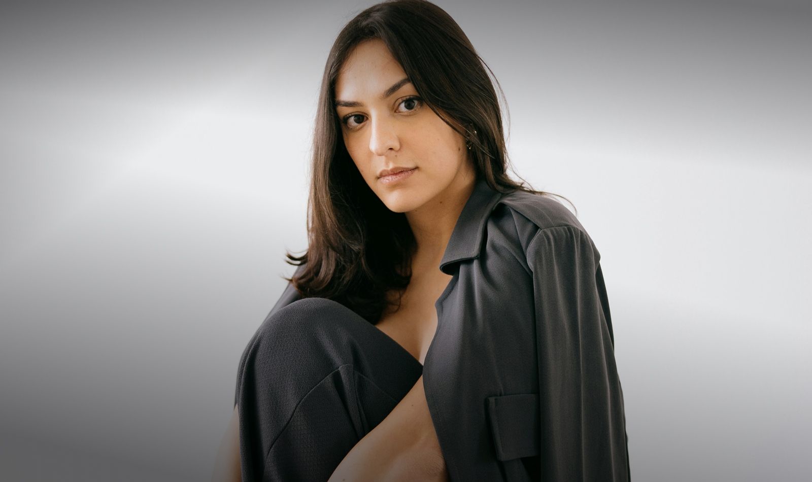 Woman in stylish outfit posing confidently indoors.