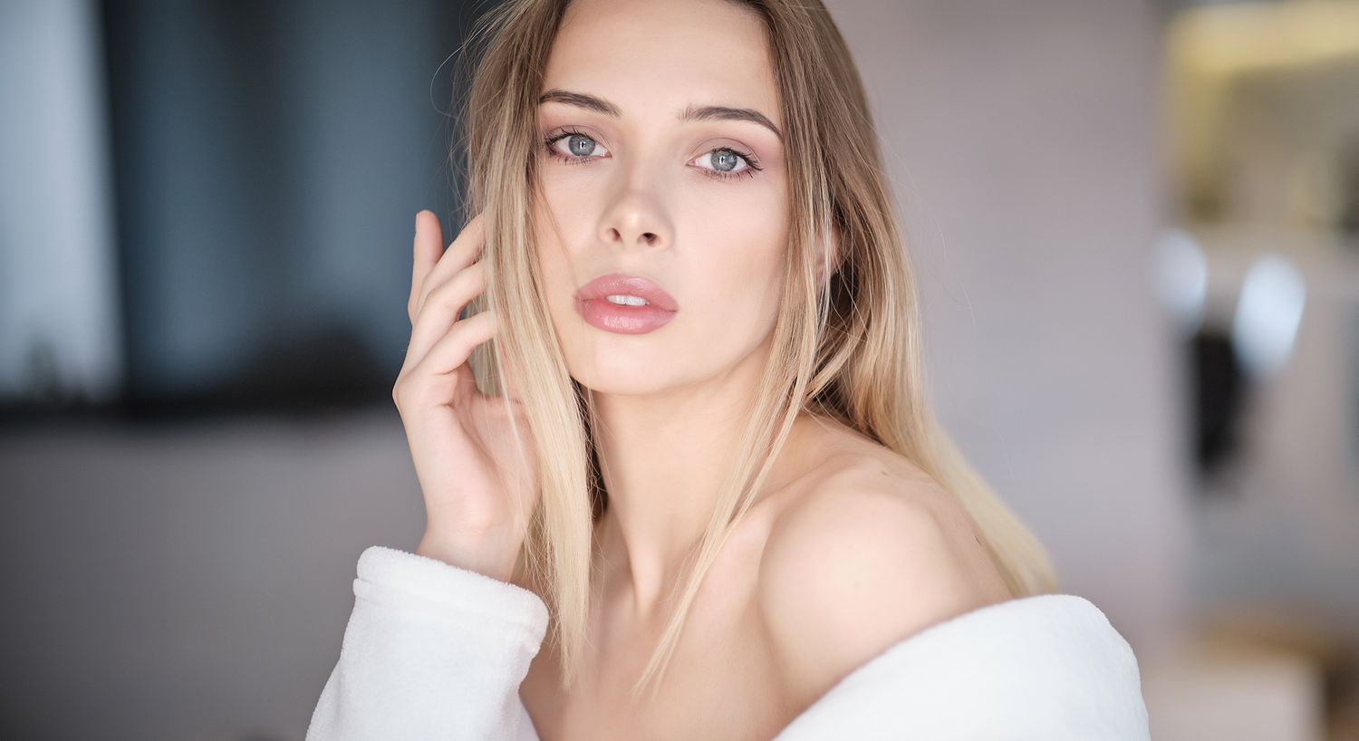Woman with long hair in soft lighting.