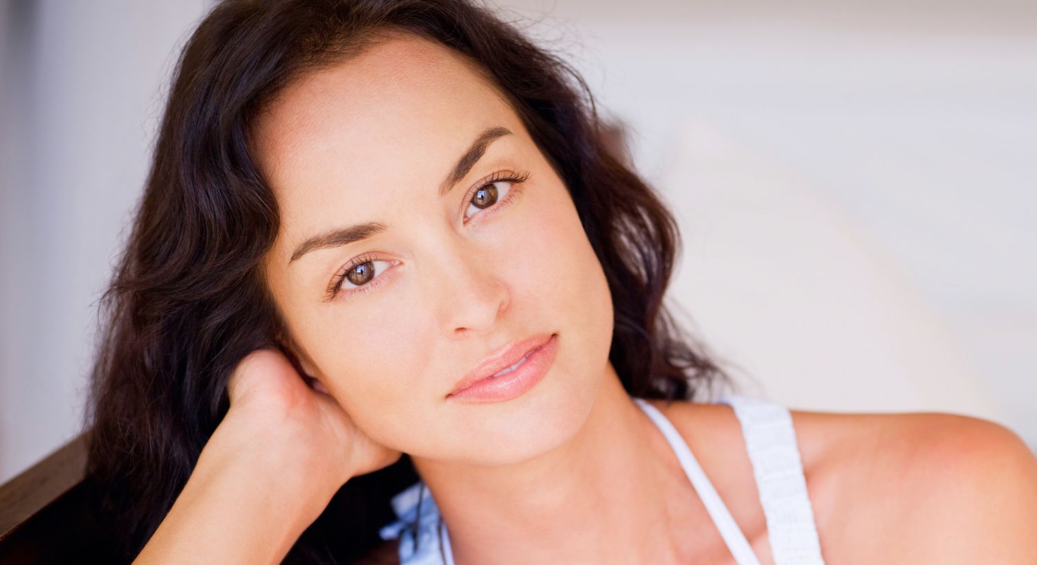 Woman with long dark hair and soft expression.