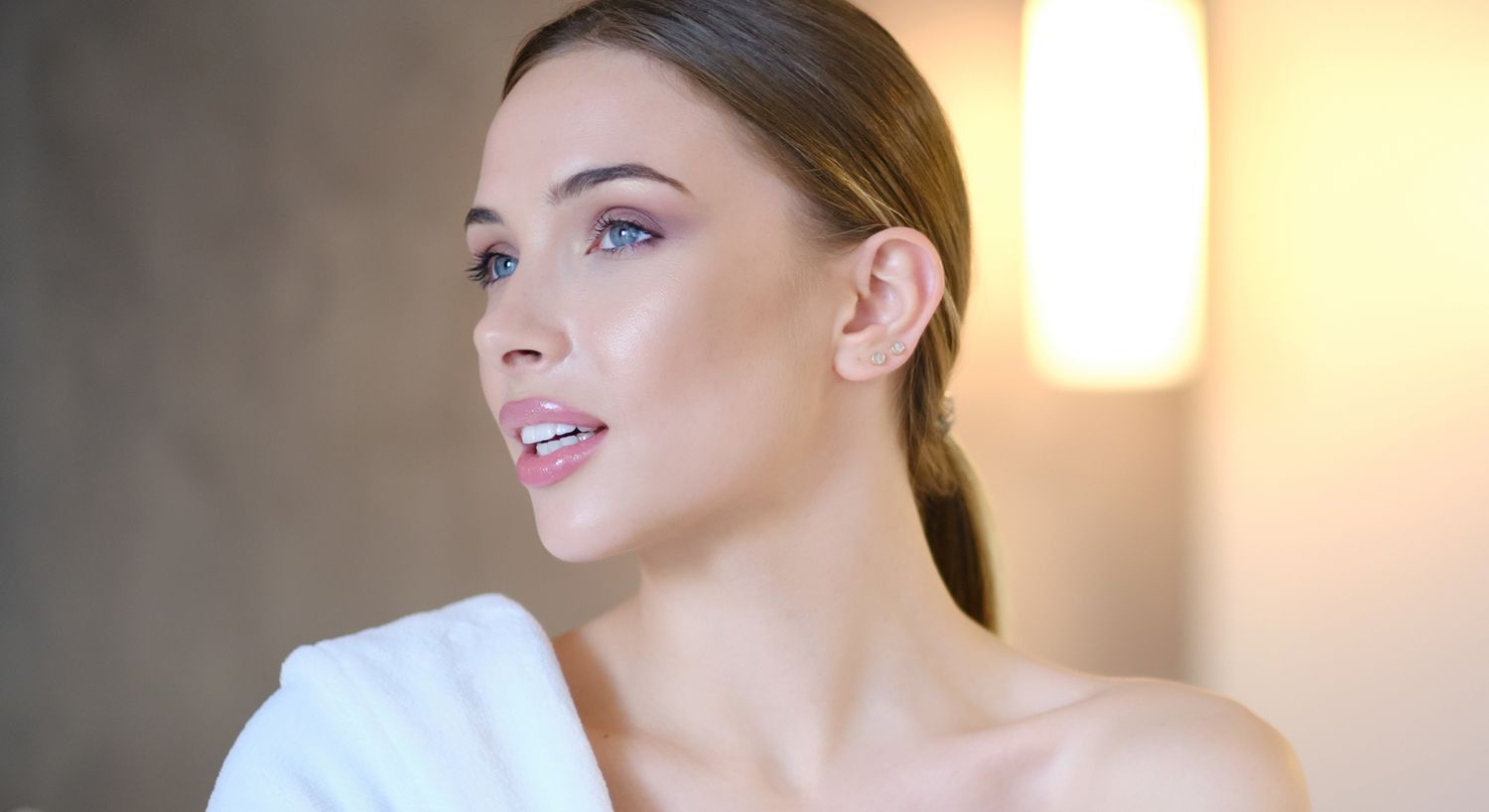 Woman with natural makeup and soft lighting.